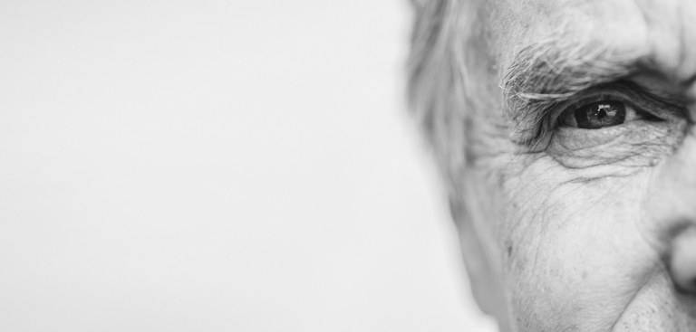 Foto em preto e branco de close do lado direito do rosto de um senhor idoso